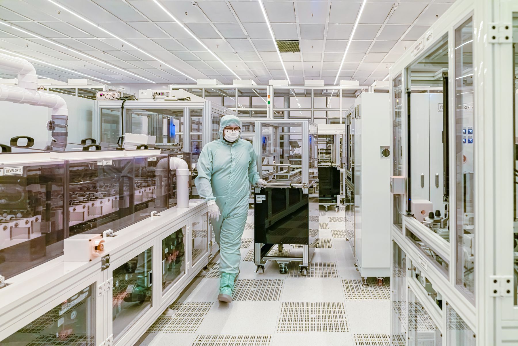 Cleanroom biotechnology manufacturing team and stainless processing equipment